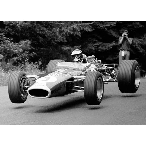 Jim Clark driving his Lotus 33 Ford DFV gets airbourne at the FluF1 Grand Prixlatz during the German Grand Prix at the Nurburgring | TotalPoster